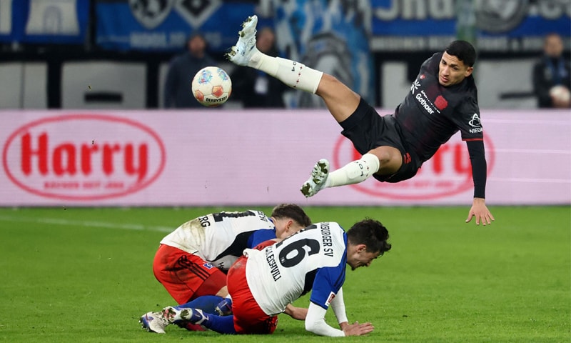 BAYER Leverkusen&rsquo;s Ezequiel Fernandez (R) ends up in the air over Nicolai Remberg (L) and Giorgi Gocholeishvili of Hamburg during their Bundesliga match at Volsparkstadion.&mdash;AFP