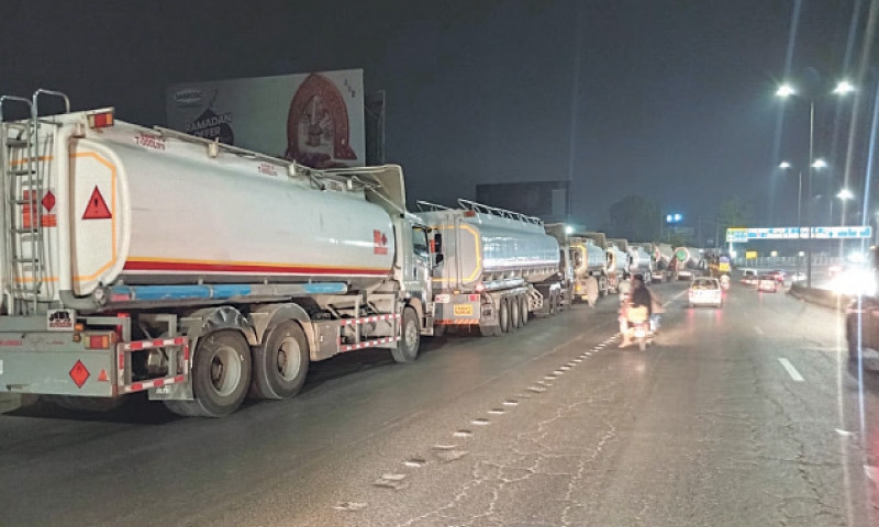 A long queue of empty oil tankers is seen at Karal Chowk in Islamabad as they return to fuel terminals after refilling petrol stations following daylong panic buying by residents of the twin cities. The government on Friday night announced an unprecedented Rs55 per litre increase in petrol and diesel prices due to rising international oil prices triggered by the Middle East crisis. &mdash; Photo by Tahaam Amir