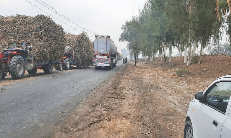 RAHIM YAR KHAN: As one side of the two-way road is blocked by sugarcane-laden tractor-trolleys over a long stretch of several kilometers, crossing and overtaking become difficult. &mdash; Dawn