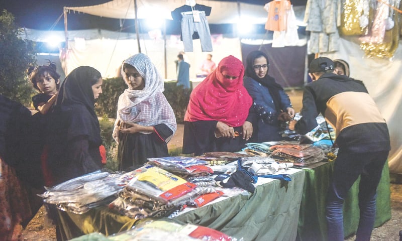 People visit one of the stalls set up by Gul Plaza vendors in Baradari of Bagh-i-Jinnah. &mdash;Fahim Siddiqi / White Star