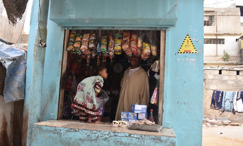 A man pictured at his small shop in Hasan Aulia Village: in such informal settlements, the defiant act of living is a ceaseless negotiation| All pictures and maps courtesy the writer