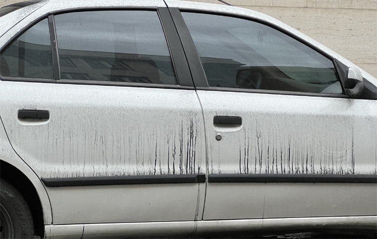  OIL mixed with rain drips down the side of a car in Tehran.—X / RKhanizadeh 