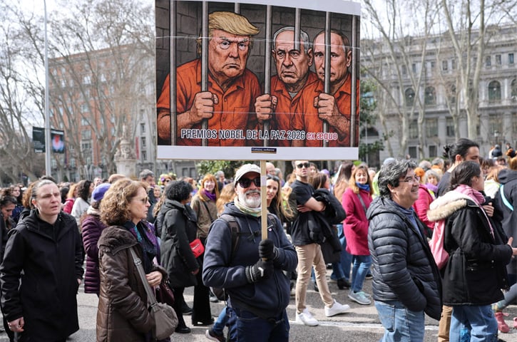  Madrid: An anti-war activist holds a banner mocking US President Donald Trump, Israeli Prime Minister Benjamin Netanyahu and Russia&rsquo;s President Vladimir Putin during a demonstration marking the International Women&rsquo;s Day on Sunday. Thousands of people marched through the streets of the Spanish capital to call for equality and an end to violence against women, also protesting against the wars in the Middle East and Ukraine.&mdash;AFP 