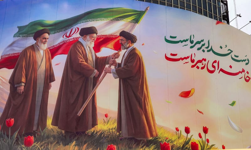 A BANNER at Tehran&rsquo;s Valiasr Square depicts Iran&rsquo;s late supreme leader Ayatollah Ruhollah Khomeini (left) watching as his successor, the late Ayatollah Ali Khamenei (centre), hands over the national flag to his son and new supreme leader, Mojtaba Khamenei. &mdash; Reuters