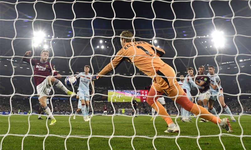 LONDON: West Ham United&rsquo;s Jarrod Bowen (L) scores past Brentford goalkeeper Caoimhin Kelleher during their FA Cup fifth-round match at the London Stadium.&mdash;Reuters