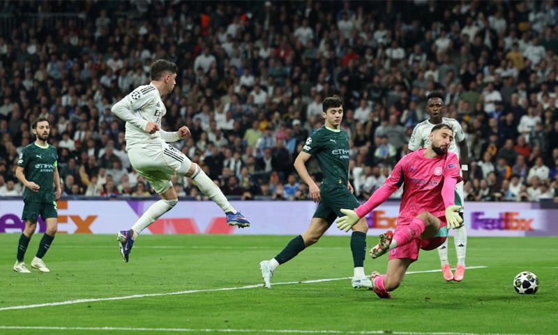 MADRID: Real Madrid&rsquo;s Federico Valverde (second L) scores past Manchester City goalkeeper Gianluigi Donnarumma during their Champions League round-of-16 first leg at Santiago Bernabeu.&mdash;Reuters