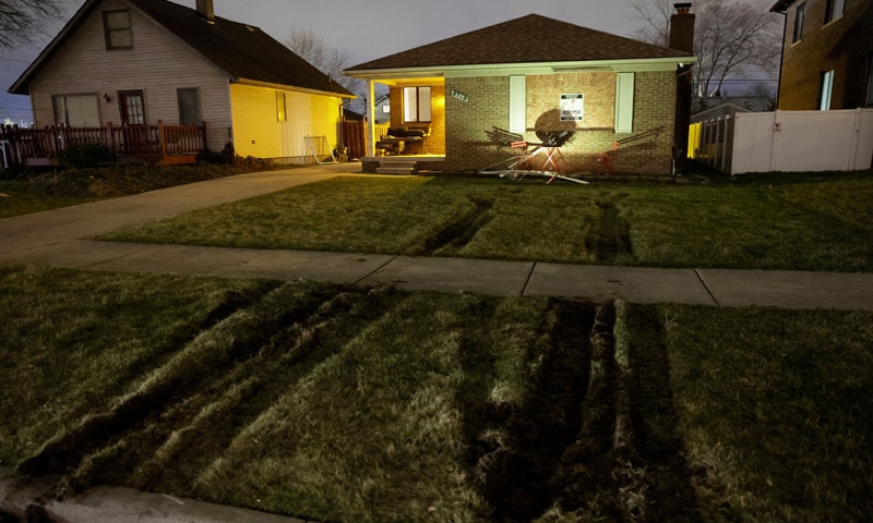 Tyre tracks on the lawn after law enforcement breached the Michigan home of Ayman Ghazali.&mdash;AFP