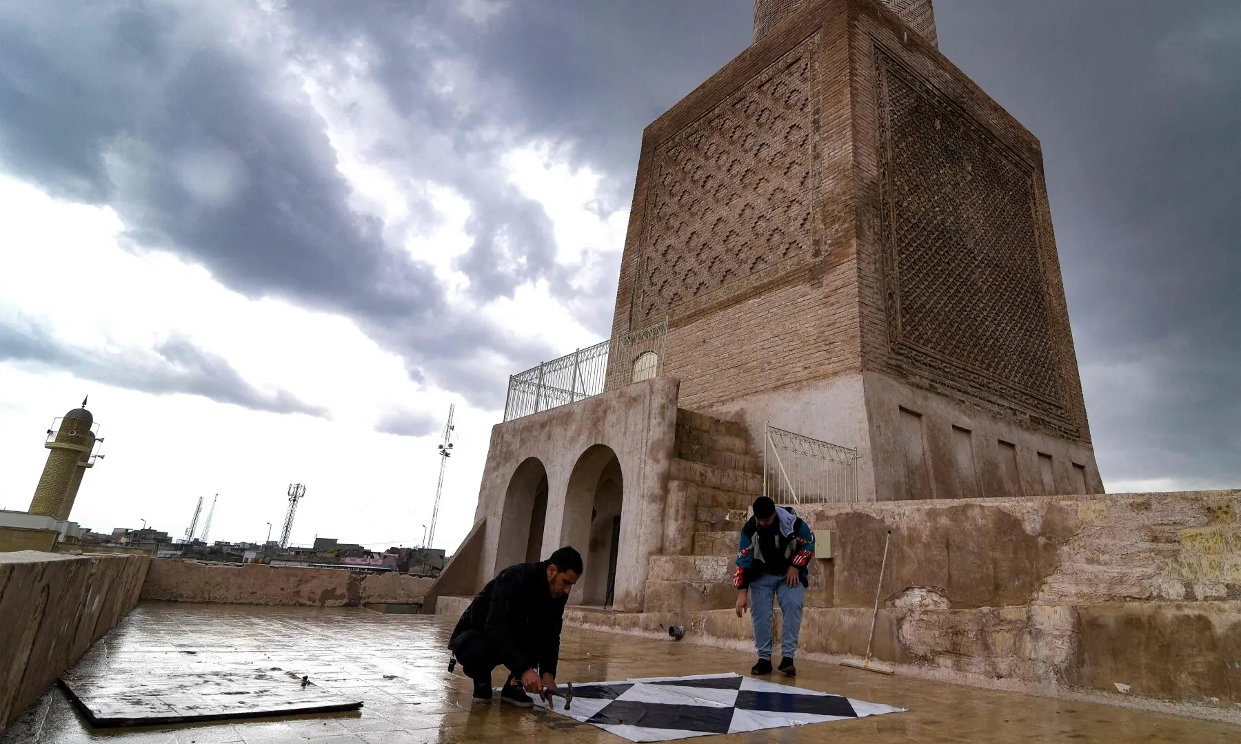 Archaeologists add the &ldquo;Blue Shield&rdquo; sign to signify cultural sites protected by the 1954 Hague Convention next to the reconstructed 12th century &lsquo;Hadba&rsquo; leaning minaret at the historic Great Mosque of al-Nuri in the old city of Mosul, Iraq on March 31. &mdash; AFP