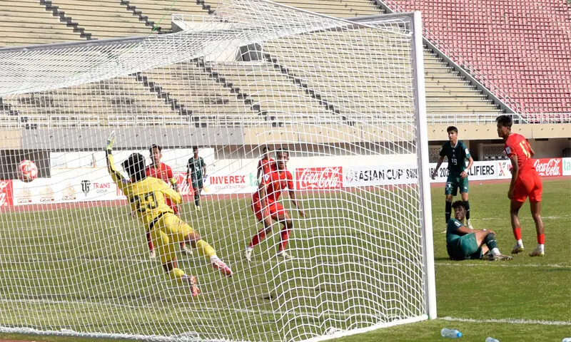 PAKISTAN Shayek Dost (second R) scores past Myanmar goalkeeper Zin Nyi Nyi Aung during their AFC Asian Cup qualifier at the Pakistan Sports Complex on Tuesday.—Tanveer Shahzad/White Star PAKISTAN Shayek Dost (second R) scores past Myanmar goalkeeper Zin Nyi Nyi Aung during their AFC Asian Cup qualifier at the Pakistan Sports Complex on Tuesday.—Tanveer Shahzad/White Star