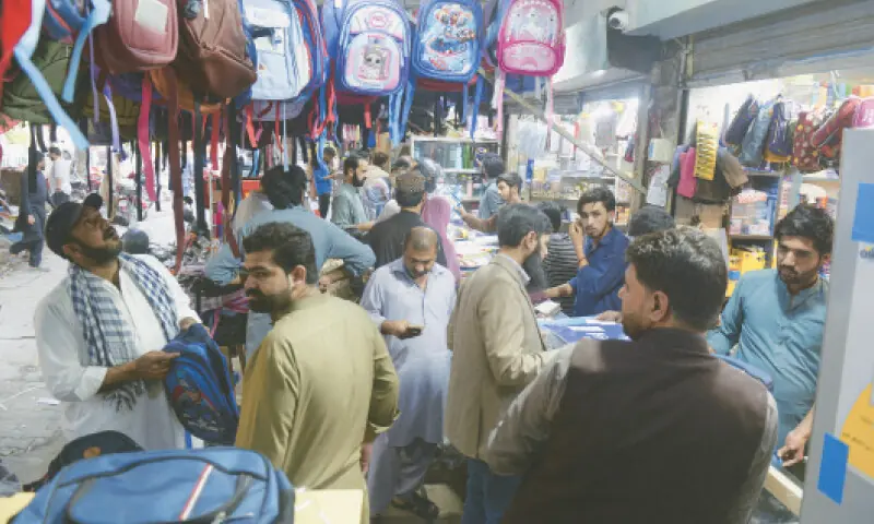 Customers throng a book store in Cooperative Market in G-6, Islamabad, to purchase stationery items as new academic year starts with the reopening of educational institutions on Wednesday (today). &mdash; Photo by Mohammad Asim