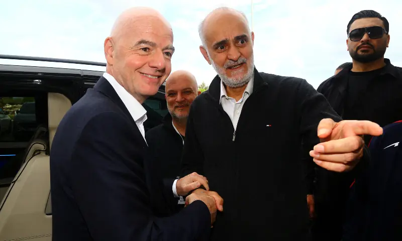 vice-president of Iran Football Federation Mehdi Mohammad Nabi (second R) shakes hands with FIFA president Gianni Infantino before the match on Tuesday.—Reuters vice-president of Iran Football Federation Mehdi Mohammad Nabi (second R) shakes hands with FIFA president Gianni Infantino before the match on Tuesday.—Reuters
