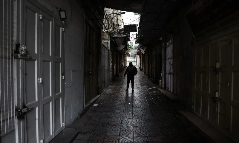 A man stands in an empty alley in Hebron, in the Israeli-occupied West Bank, on April 1, 2026, during a general strike to protest a bill approved by the Israel’s parliament. — AFP A man stands in an empty alley in Hebron, in the Israeli-occupied West Bank, on April 1, 2026, during a general strike to protest a bill approved by the Israel’s parliament. — AFP