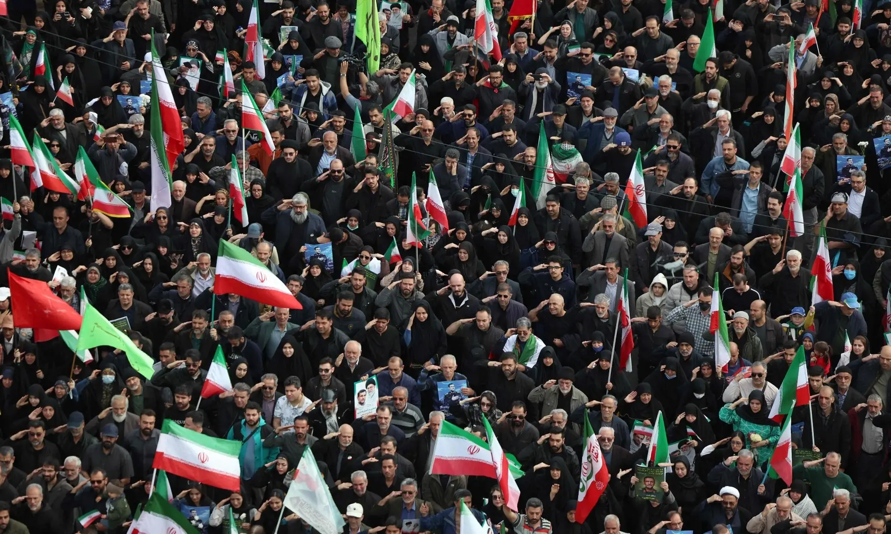 People salute during the funeral of Alireza Tangsiri, the assassinated commander of the Iranian Revolutionary Guards&rsquo; navy, in Enghelab Square in Tehran, Iran on April 1. &mdash; AFP