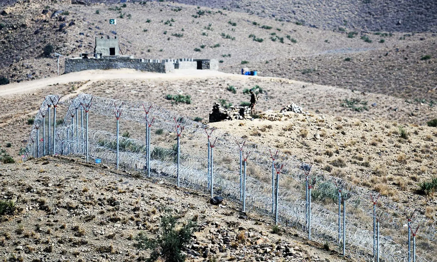 A Pakistani soldier keeps vigil beside a newly fenced border fencing along Afghan border at Kitton Orchard Post in Pakistan&rsquo;s North Waziristan tribal agency on October 18, 2017. &mdash; AFP/ File