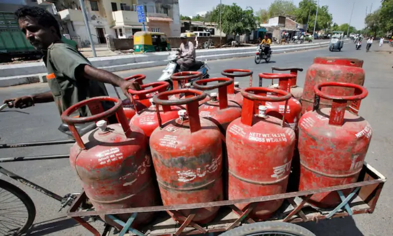 A man pushes a trishaw loaded with cooking gas cylinders in the western Indian city of Ahmedabad April 29, 2010. — Reuters A man pushes a trishaw loaded with cooking gas cylinders in the western Indian city of Ahmedabad April 29, 2010. — Reuters