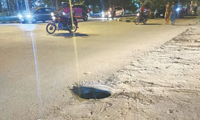 An open manhole in Johar Town. &mdash; Dawn