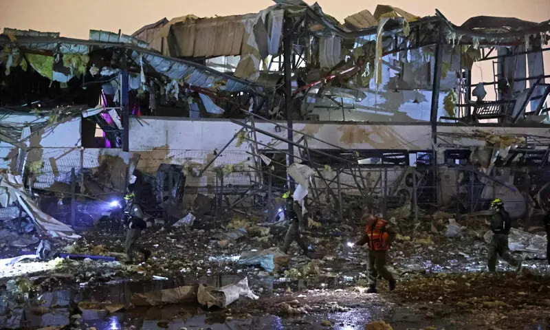ISRAELI security forces and first responders inspect the site of an Iranian strike that hit a residential neighbourhood in Petah Tikva.—AFP ISRAELI security forces and first responders inspect the site of an Iranian strike that hit a residential neighbourhood in Petah Tikva.—AFP