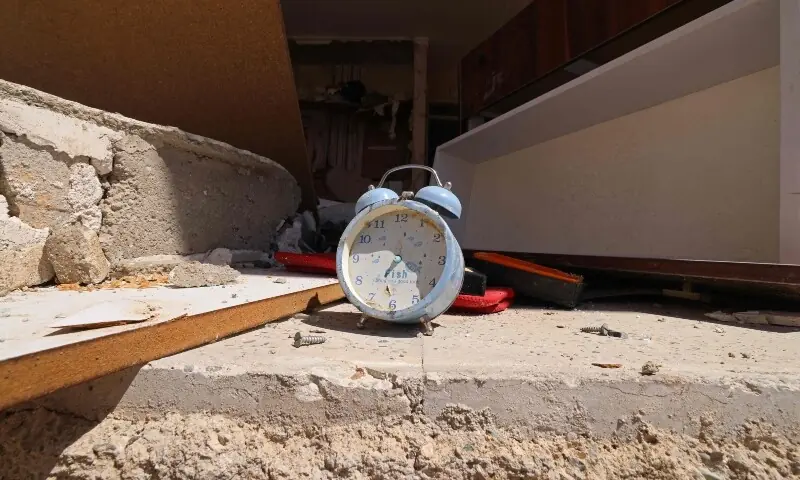 A clock is pictured amid the debris of a residential apartment that was damaged by recent strikes at Vahdat town in Karaj, southwest of Tehran on April 3. &mdash; AFP