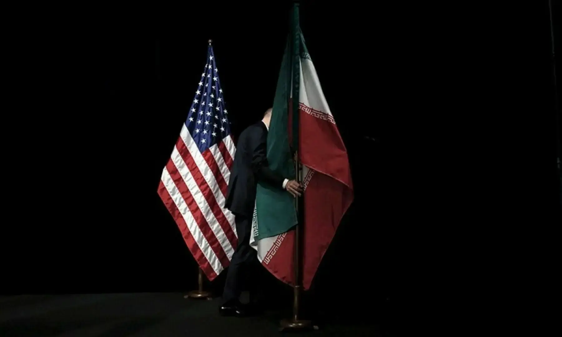 In this file photo, a staff member removes the Iranian flag from the stage after a group picture with foreign ministers and representatives of the US, Iran, China, Russia, Britain, Germany, France and the European Union during Iran nuclear talks at the Vienna International Center in Vienna, Austria in July 14, 2015. — Reuters In this file photo, a staff member removes the Iranian flag from the stage after a group picture with foreign ministers and representatives of the US, Iran, China, Russia, Britain, Germany, France and the European Union during Iran nuclear talks at the Vienna International Center in Vienna, Austria in July 14, 2015. — Reuters