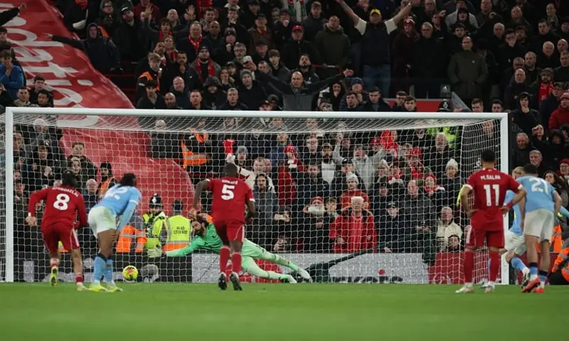 LIVERPOOL: Manchester City&rsquo;s Erling Haaland (R, obscure) scores from the penalty spot against Liverpool during their Premier League match at Anfield on Sunday.&mdash;Reuters