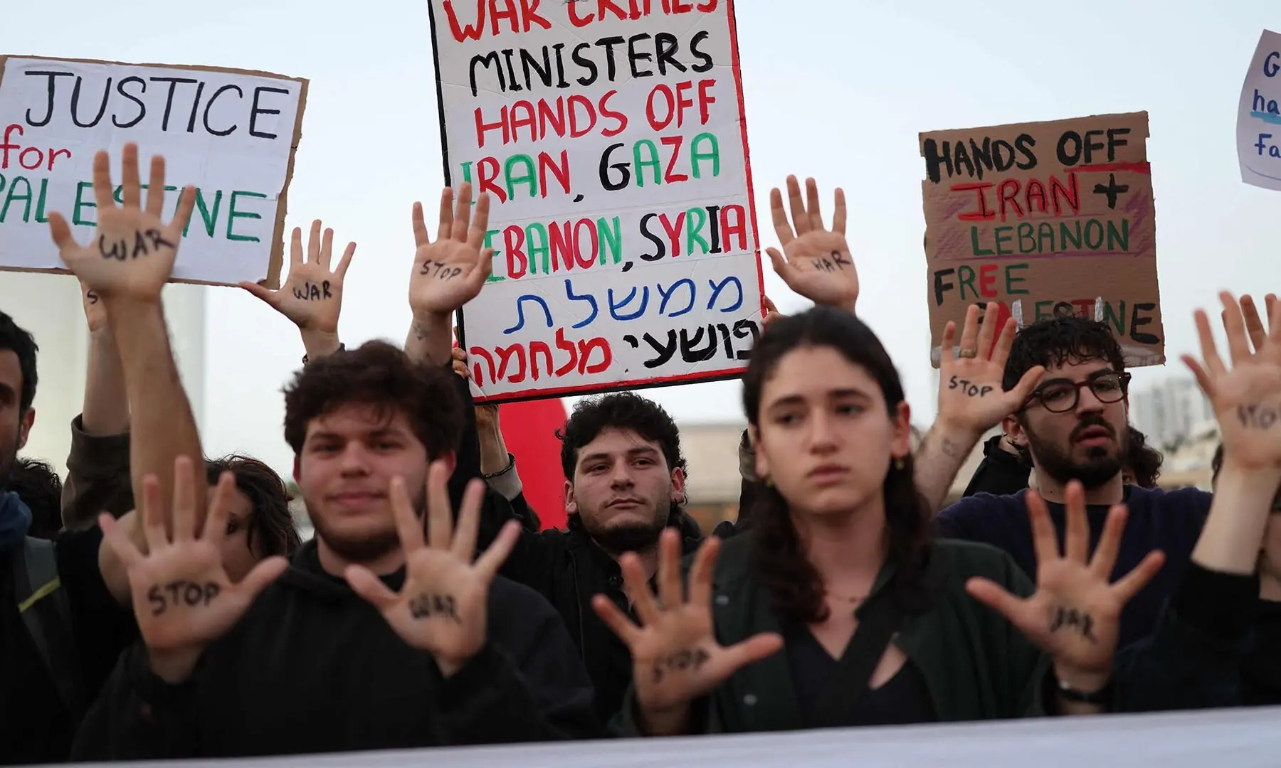 Israeli left-wing activists hold placards while taking part in a protest at HaBima Square in Tel Aviv, Israel on April 4, against the ongoing war with Iran. — AFP