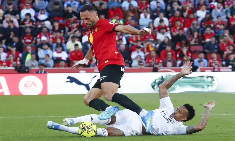 MALLORCA: Vedat Muriqi (top) of Mallorca vies for the ball with Real Madrid’s Eder Militao during their La Liga match at the Son Moix Stadium on Saturday.—AFP MALLORCA: Vedat Muriqi (top) of Mallorca vies for the ball with Real Madrid’s Eder Militao during their La Liga match at the Son Moix Stadium on Saturday.—AFP