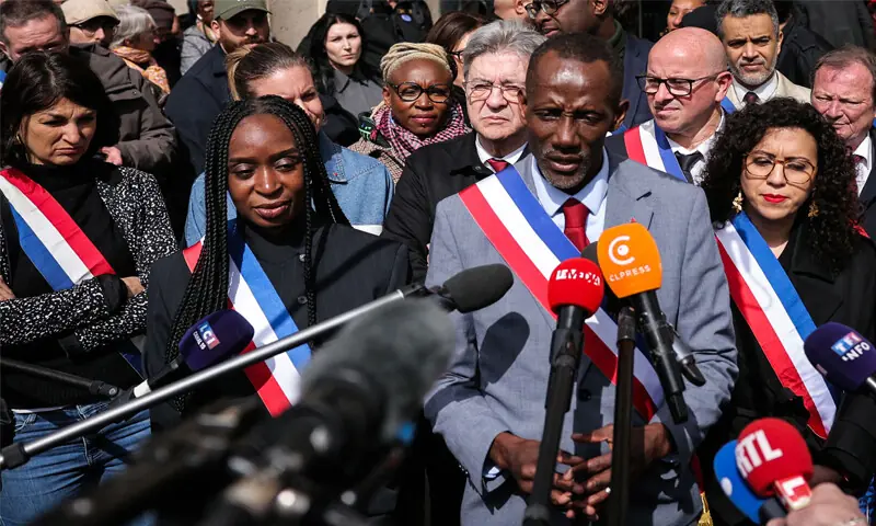 SAINT-DENIS mayor Bally Bagayoko (centre), accompanied by Jean-Luc Melenchon(rear), the founder of French left-wing party La France Insoumise, speaks to the press during the rally.&mdash;AFP