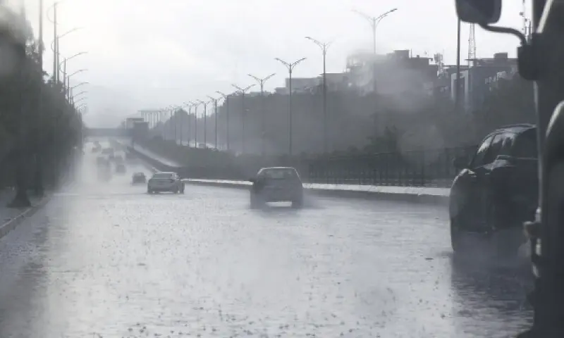 Vehicles ply in heavy rain on Jinnah Avenue in Islamabad on Saturday. &mdash; Photo by Tanveer Shazad