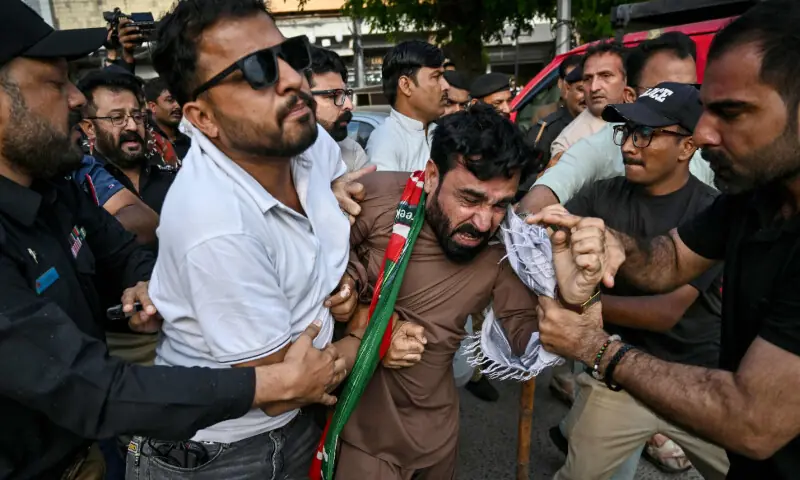 Police personnel detain supporters of PTI as they protest against a fuel price hike in Karachi on April 5, 2026. &mdash; AFP