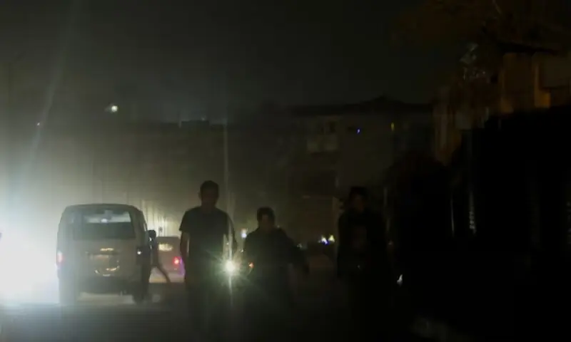 An Egyptian family uses a lantern on a street as power cuts to reduce energy consumption are executed by the Egyptian government during the current brutal heat wave, in Cairo, Egypt August 3, 2023. &mdash;Reuters/File