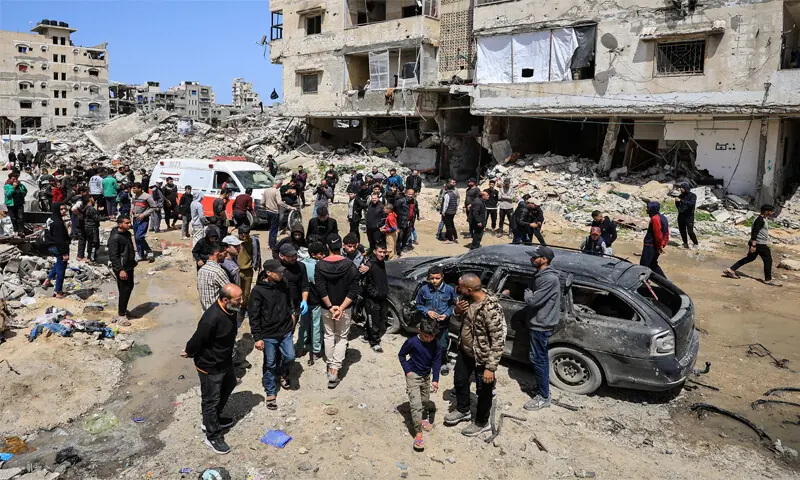 Palestinians inspect the damage after a person was hit by an Israeli air strike while riding a bicycle in
Gaza City.—Reuters Palestinians inspect the damage after a person was hit by an Israeli air strike while riding a bicycle in
Gaza City.—Reuters
