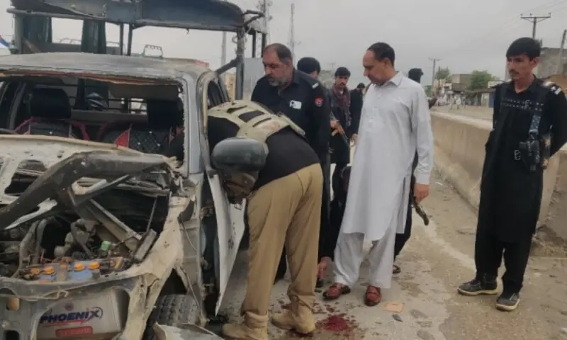Police officials inspecting the blast-hit van in Lakki Marwat. —Photo provided by author Police officials inspecting the blast-hit van in Lakki Marwat. —Photo provided by author