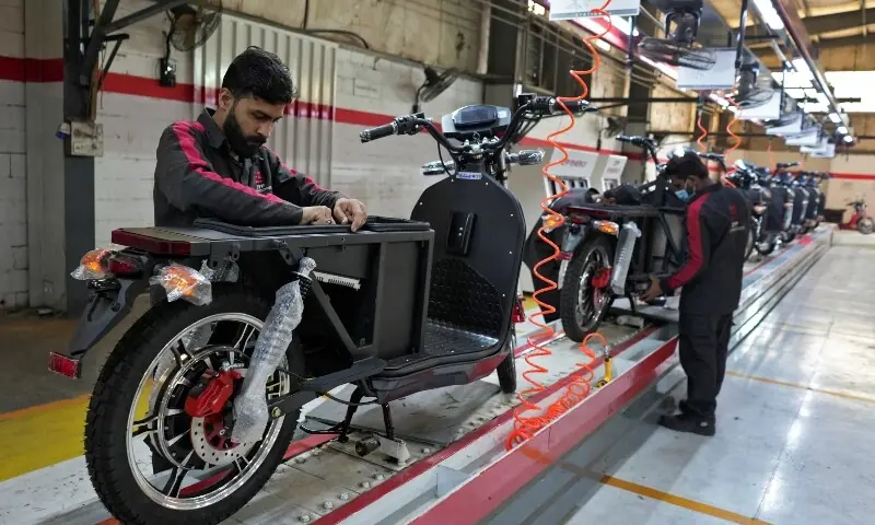 Workers assemble parts of electric motorcycles on the production line at the ZYP Technology&rsquo;s facility in Lahore, Pakistan, March 12, 2025. &mdash;Reuters/File