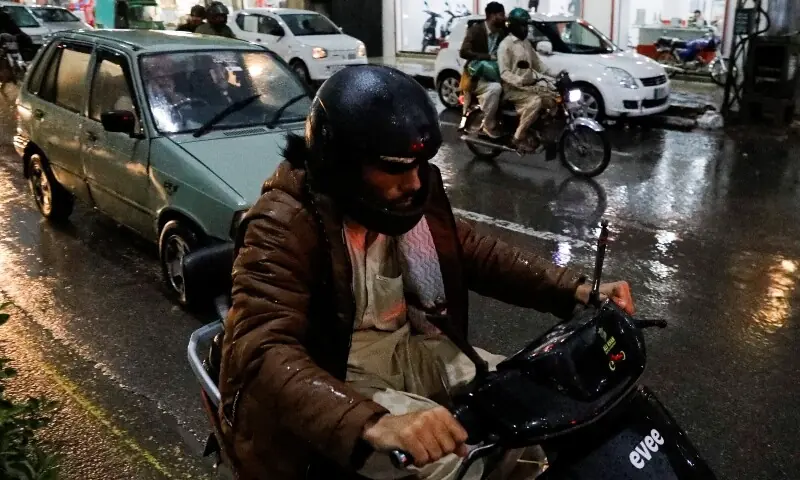 A man rides on an electric motorcycle along a road in Rawalpindi, Pakistan, March 30, 2026. &mdash;Reuters/File