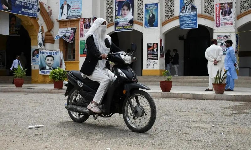 Mehwish Qureshi, 33, an advocate, rides on her electric motorcycle in Hyderabad, Pakistan April 2, 2026. &mdash;Reuters