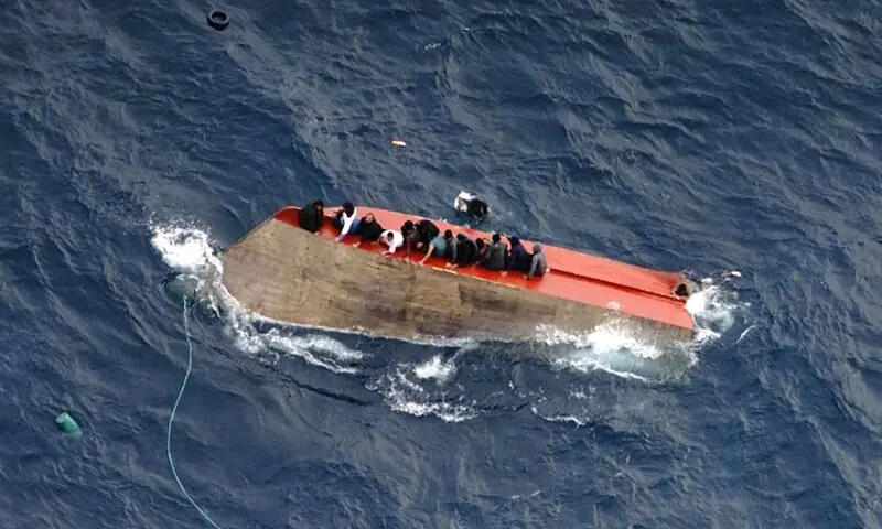 This photo taken on April 4, 2026 and handout on April 5, 2026 by German NGO Sea-Watch, shows migrants seatted on a capsized boat off Libya. &mdash;AFP/File