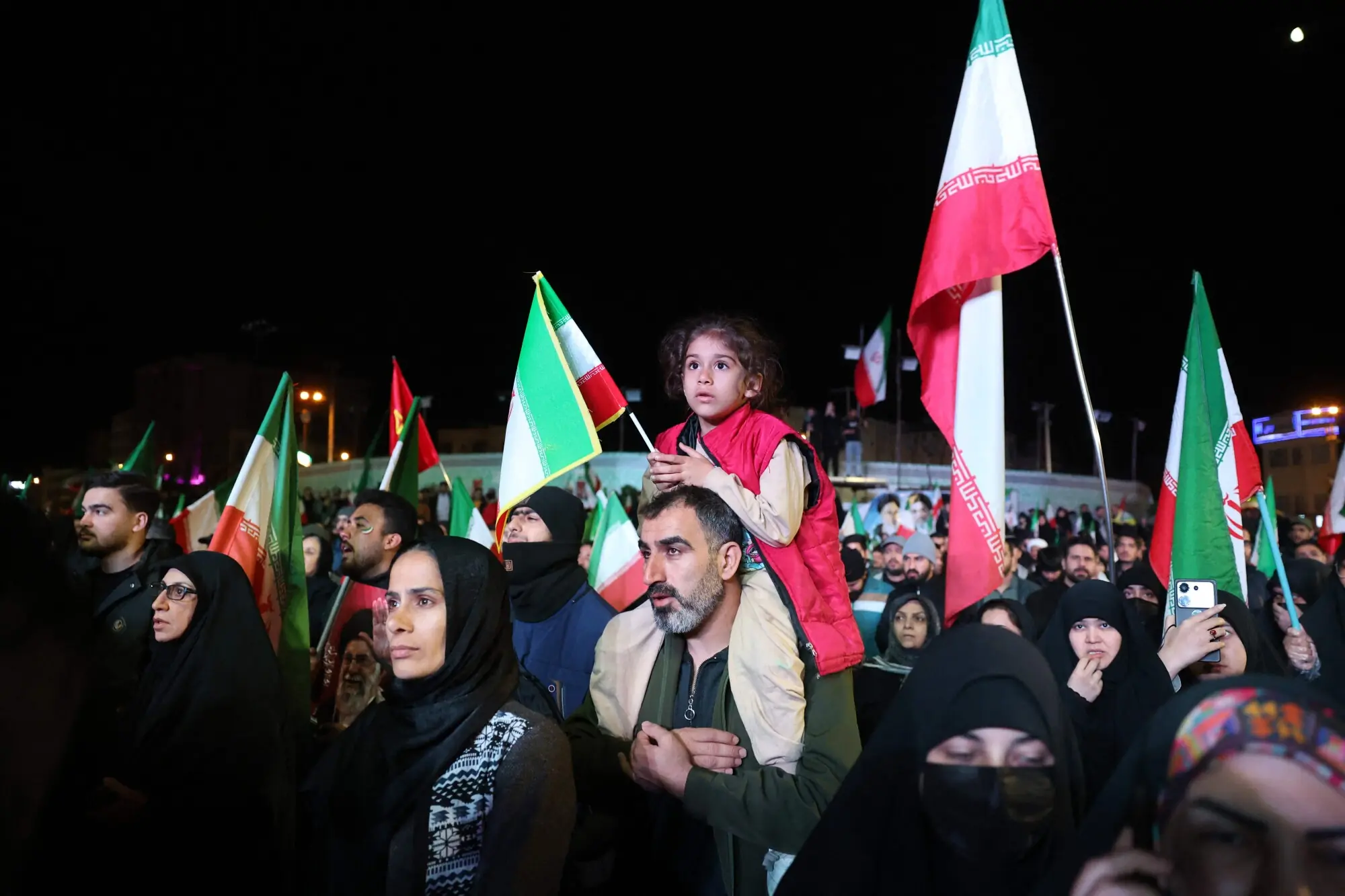 Iranians react after a ceasefire announcement at the Enqelab square, in Tehran, on April 8 2026. &mdash;AFP