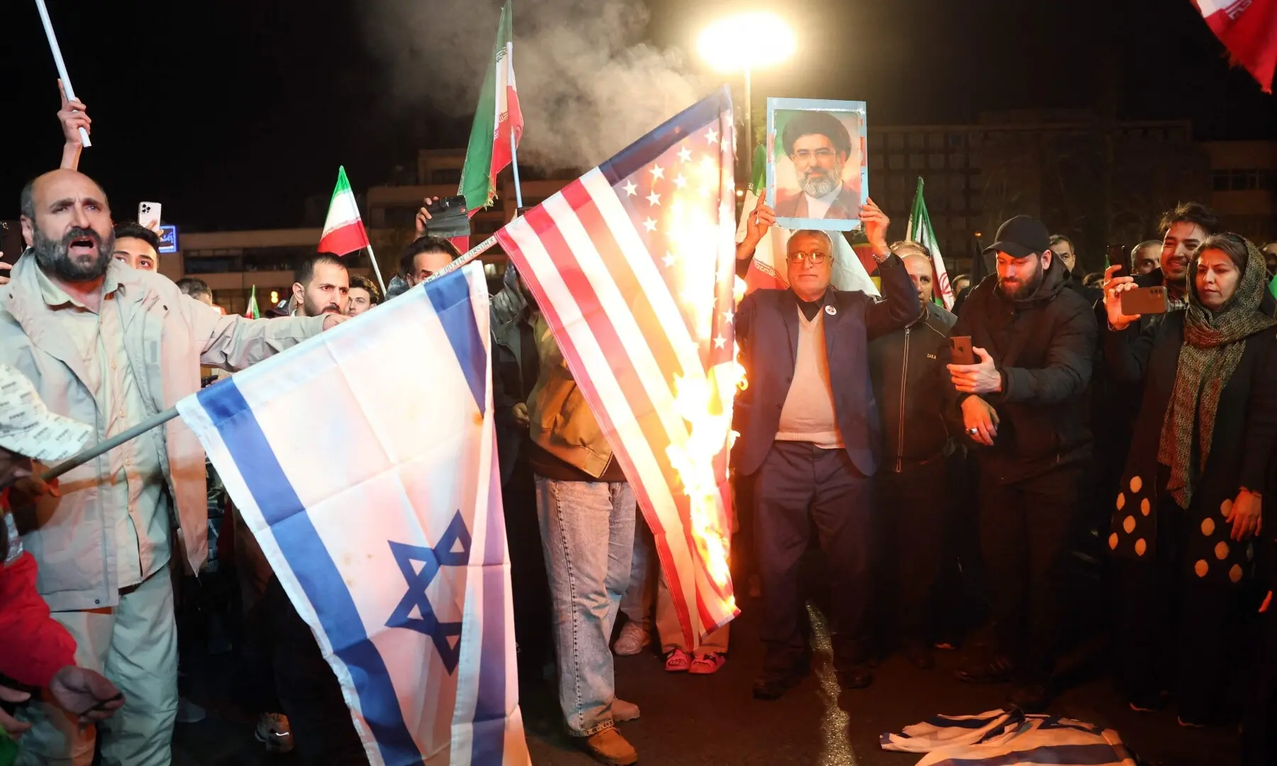 Iranians burn US and Israeli flags after the ceasefire announcement at the Enqelab square, in Tehran, on April 8, 2026. &mdash;AFP