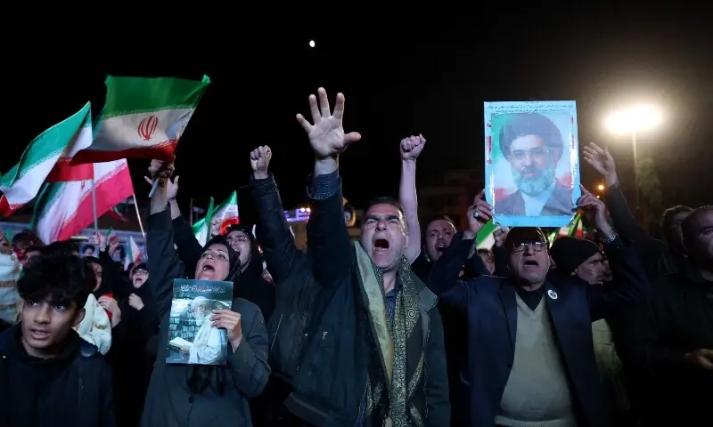 Iranians react after a ceasefire announcement at the Enqelab square, in Tehran, on April 8 2026. &mdash;AFP