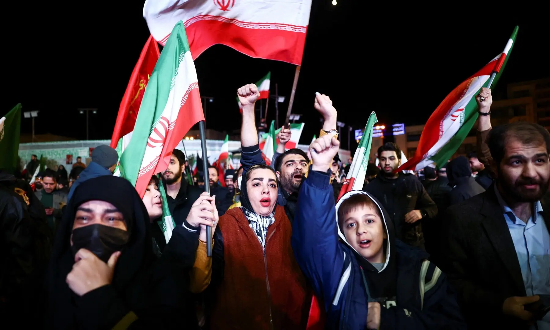 People wave flags as they gather after a two-week ceasefire in the Iran war was announced, in Tehran, Iran, April 8, 2026. &mdash;Reuters