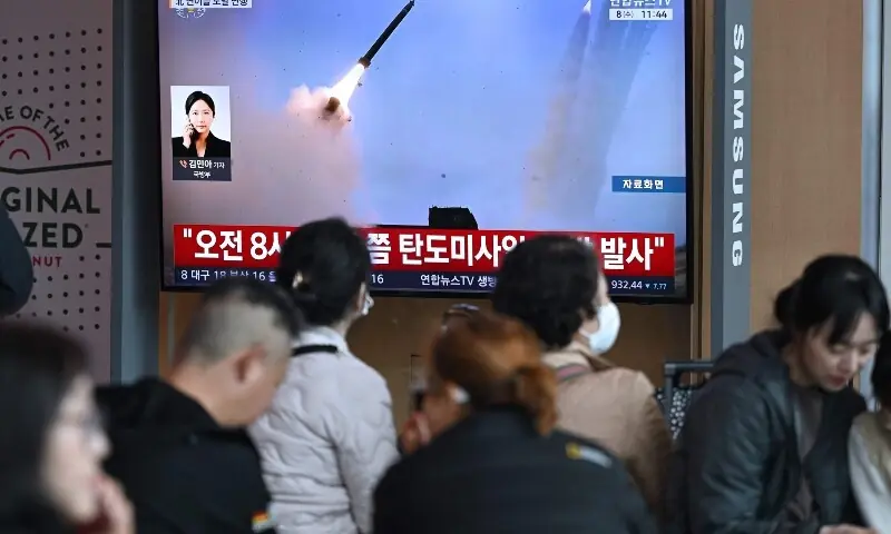 People watch a television screen showing a news broadcast with file footage of a North Korean missile test, at a train station in Seoul on April 8, 2026. —AFP People watch a television screen showing a news broadcast with file footage of a North Korean missile test, at a train station in Seoul on April 8, 2026. —AFP