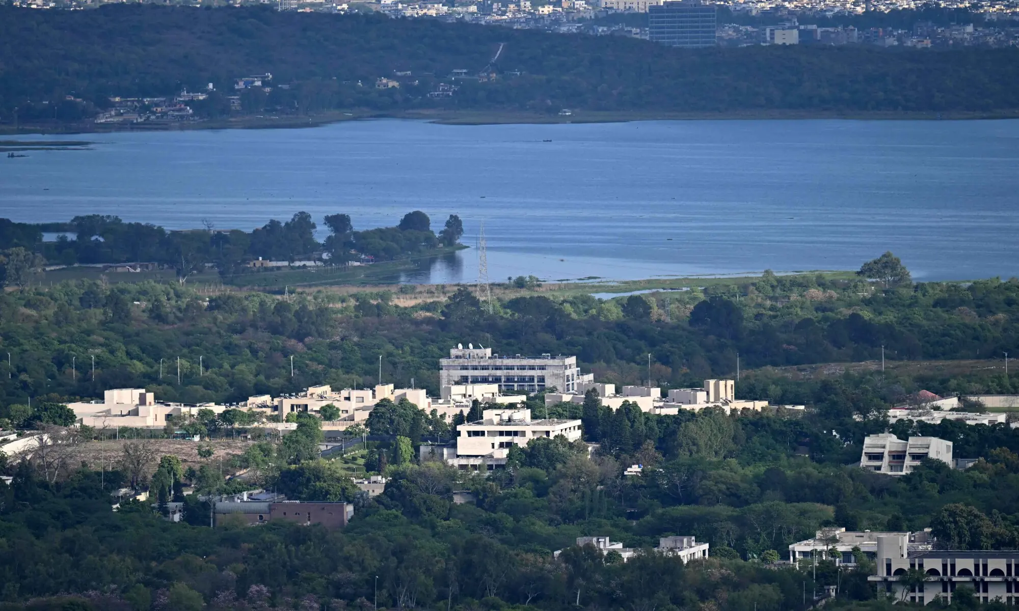 Buildings of the Diplomatic Enclave are seen near the Rawal Lake dam in Islamabad on April 8, 2026. &mdash; AFP