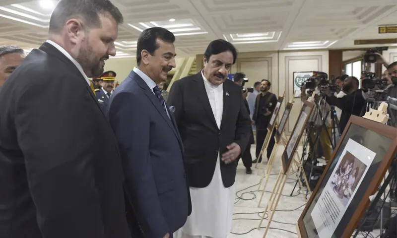 Senate Chairman Yusaf Raza Gillani Deputy Chairman Syedaal Khan and Romanian ambassador Dan Stoenescu view a picture at the exhibition of Pak-Romania Relation and launch of the national anthem of Pakistan in a choral format at Parliament House Islamabad on Wednesday. &mdash; Photo by Tanveer Shahzad