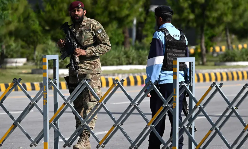 Security personnel stand guard at a checkpoint in the Red Zone area of Islamabad on April 9, 2026. — AFP Security personnel stand guard at a checkpoint in the Red Zone area of Islamabad on April 9, 2026. — AFP
