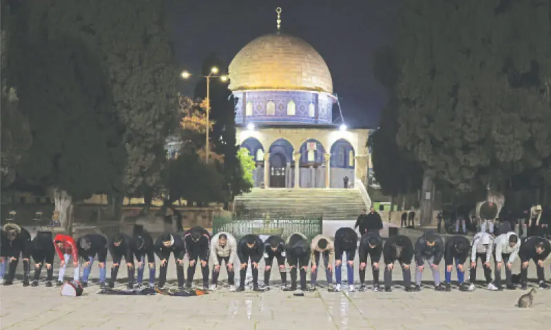 Worshippers gather near the Dome of the Rock for Fajr prayers after the Al Aqsa Mosque compound was reopened following a 41-day closure.—AFP Worshippers gather near the Dome of the Rock for Fajr prayers after the Al Aqsa Mosque compound was reopened following a 41-day closure.—AFP