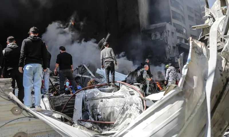 First responders and residents stand amid the rubble at the site of an Israeli airstrike in Beirut&rsquo;s Corniche al-Mazraa neighbourhood on April 8, 2026. &mdash;AFP/File