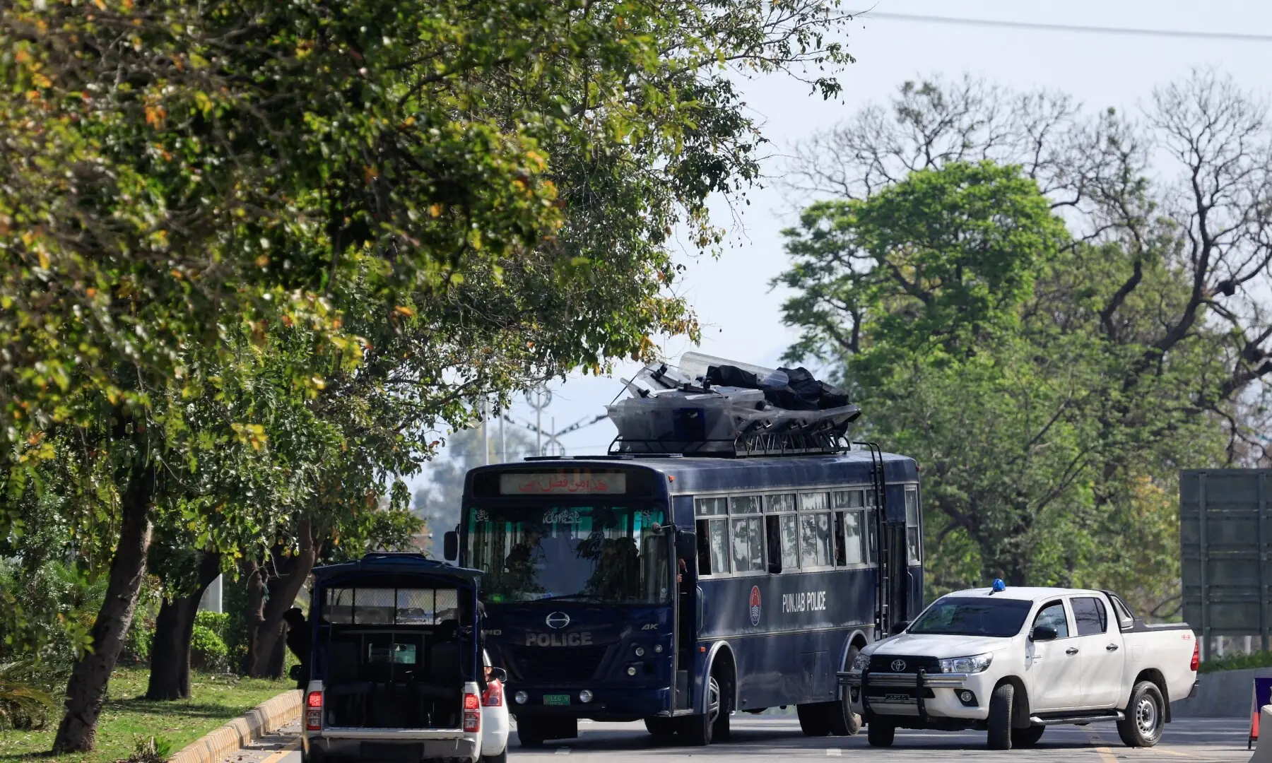 A police bus with riot gear on top moves along a road leading to the Serena hotel, as Pakistan prepares to host the US and Iran for peace talks, in Islamabad, Pakistan, April 10, 2026. &mdash;Reuters