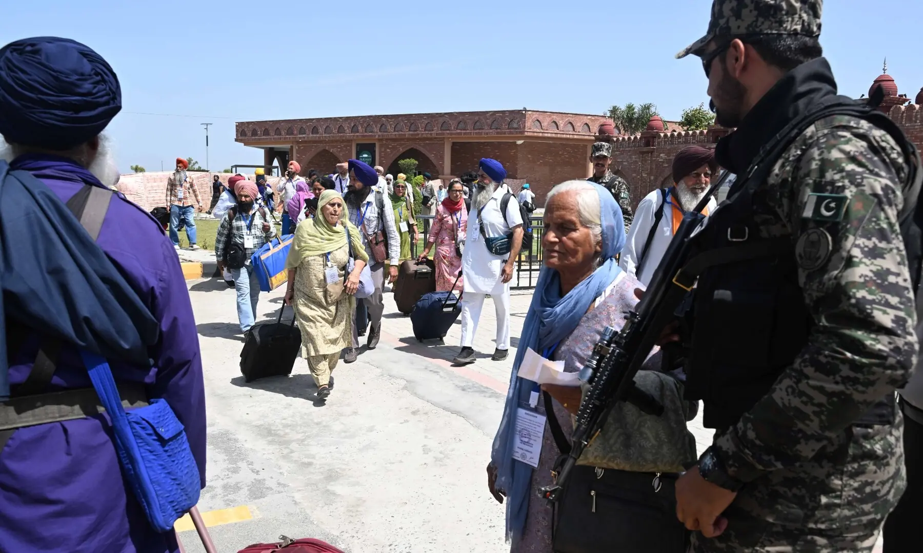 A soldier stands guard as the first batch of Sikh pilgrims arrives from India to Pakistan via Wagah border on April 10, 2026. &mdash; White Star/Arif Ali