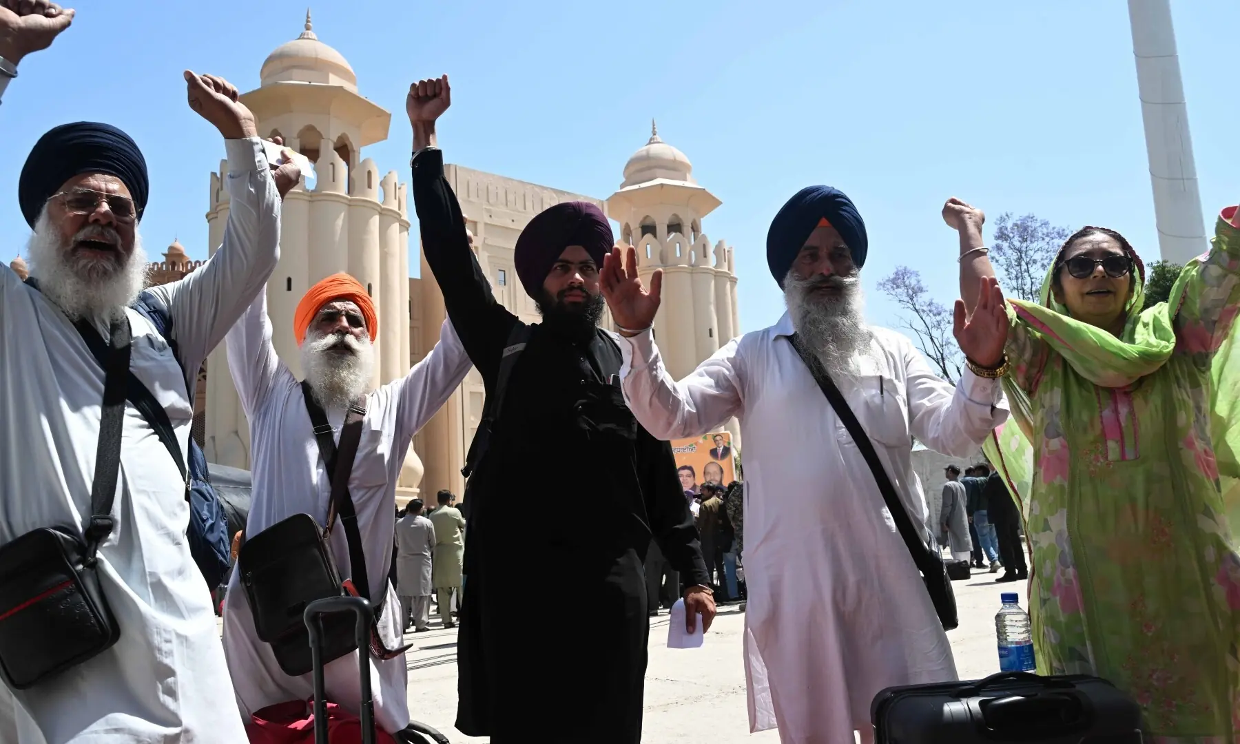 Sikh pilgrims gesture as they arrive in Pakistan from India via Wagah border on April 10, 2026. &mdash; White Star/ Arif Ali