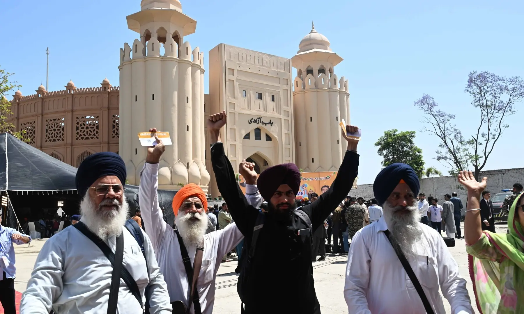 The Sikh pilgrims gesture as they arrive in Pakistan from India via Wagah border on April 10, 2026. &mdash; White Star/ Arif Ali